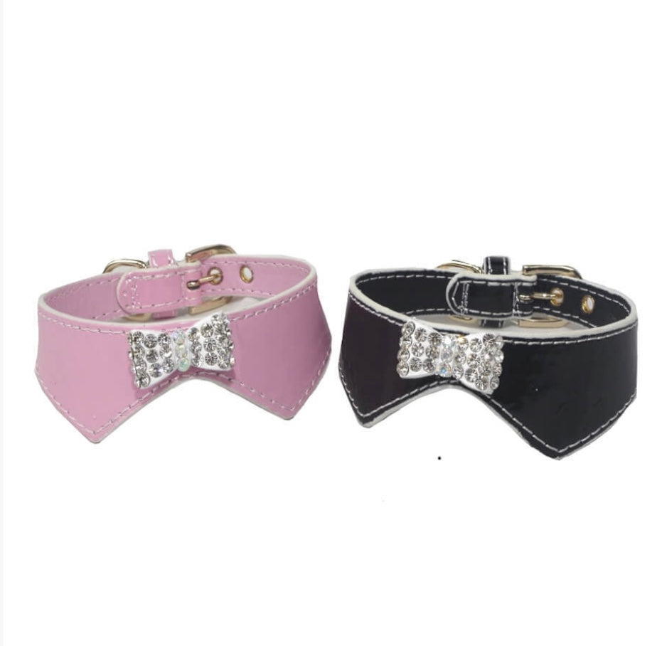 Pink and black dog collars with bow accents on a white background