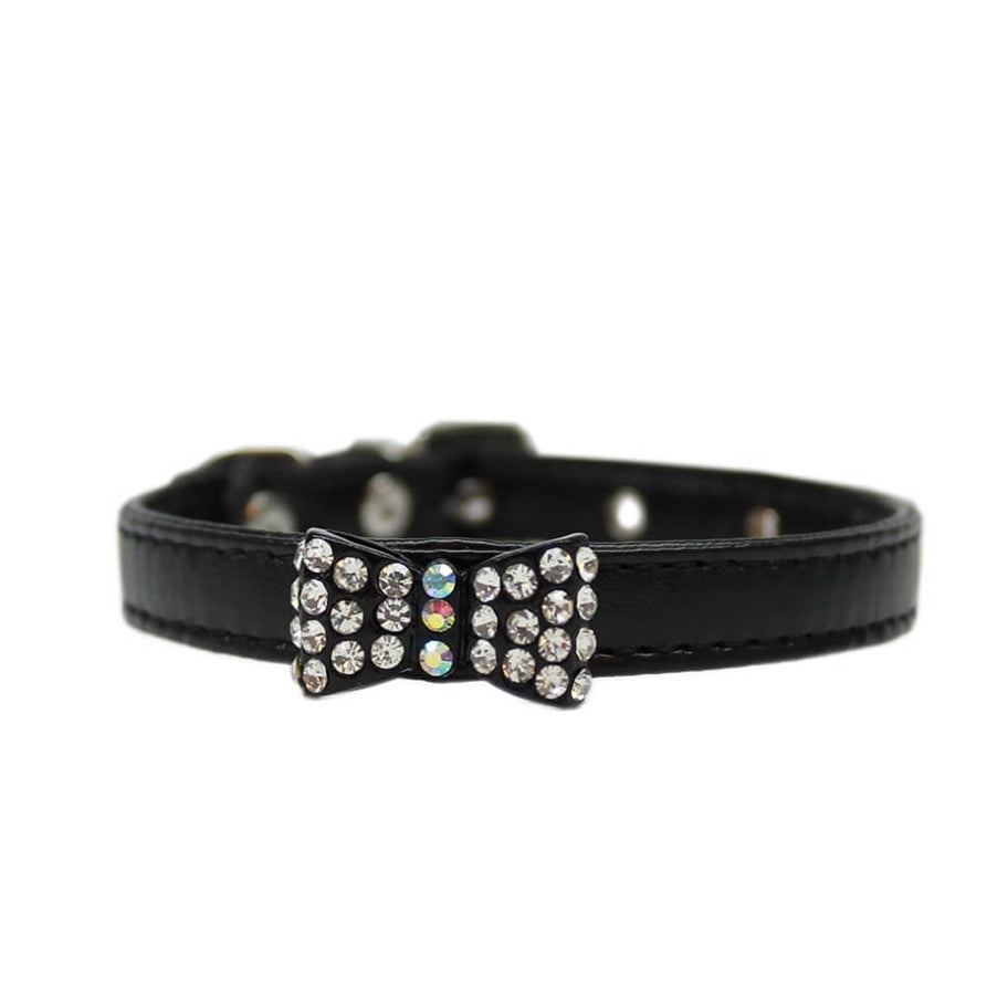Black leather dog collar with a decorative bow and rhinestones on a white background