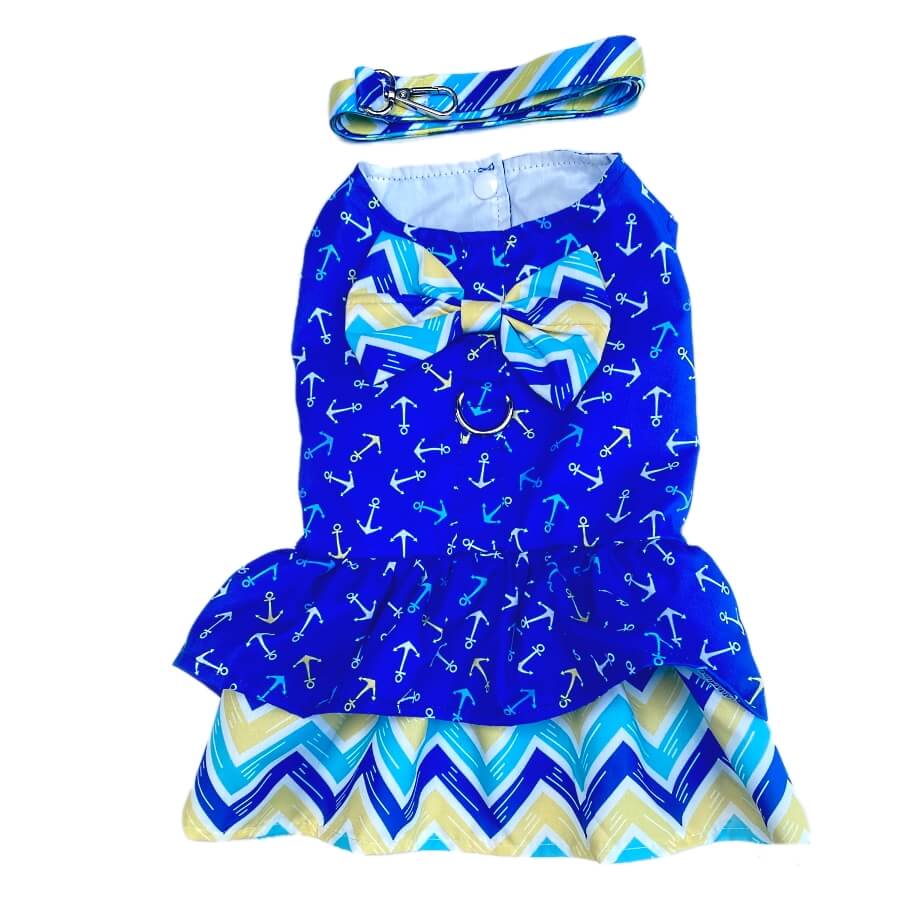 Blue dress with anchor pattern and matching headband on a white background