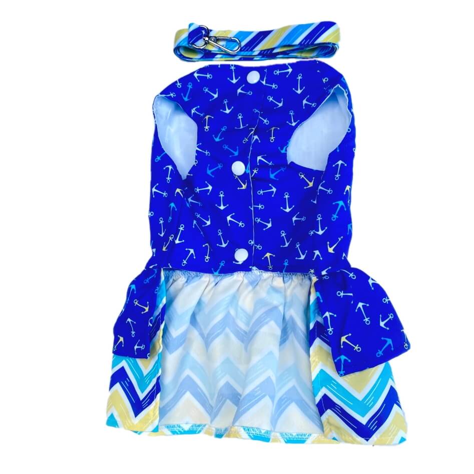 Children's outfit with blue anchor pattern top and chevron skirt on a white background