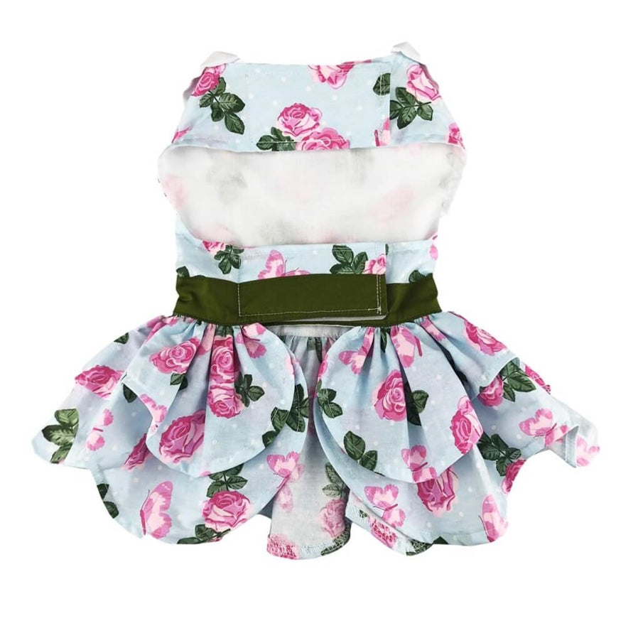 Floral pet outfit with pink roses and green leaves on a light blue background