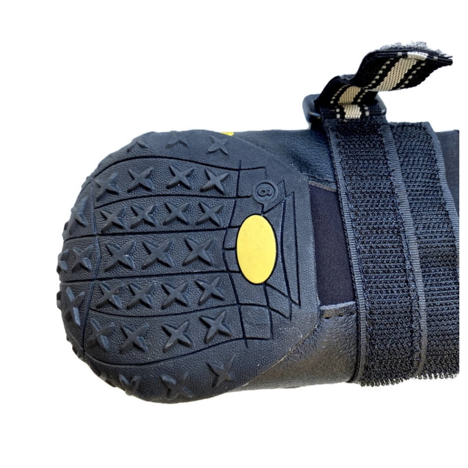 Black dog boot with yellow patch and tread pattern on a white background