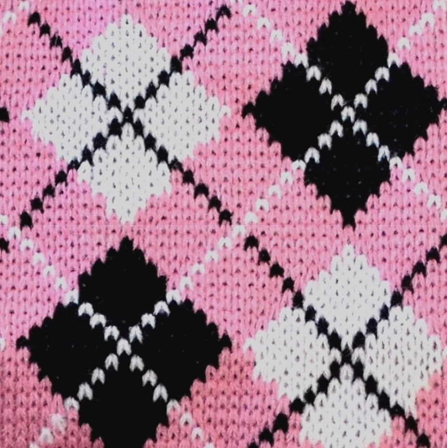 Close-up of pink fabric with black and white argyle pattern