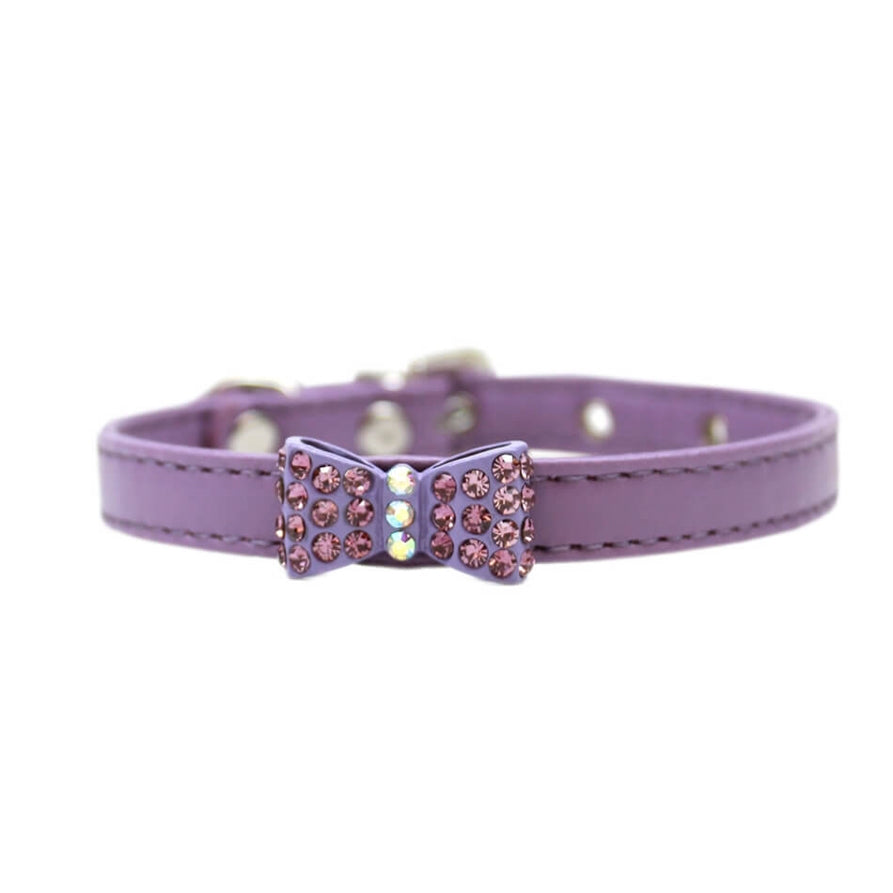Purple dog collar with a decorative bow on a white background