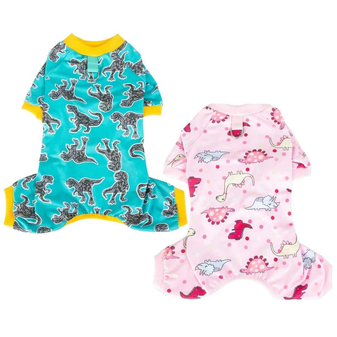 Two dog jumpsuits, one with dinosaur pattern on blue and yellow trim, the other with pink and dinosaur pattern, on a white background.
