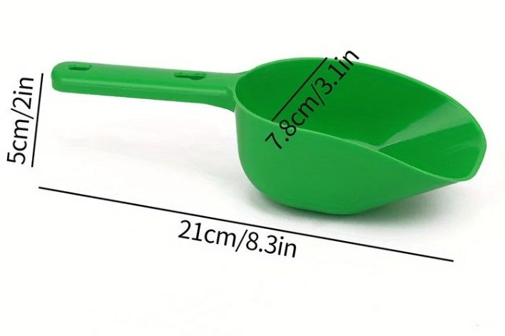 Green plastic scoop with measurements on a white background