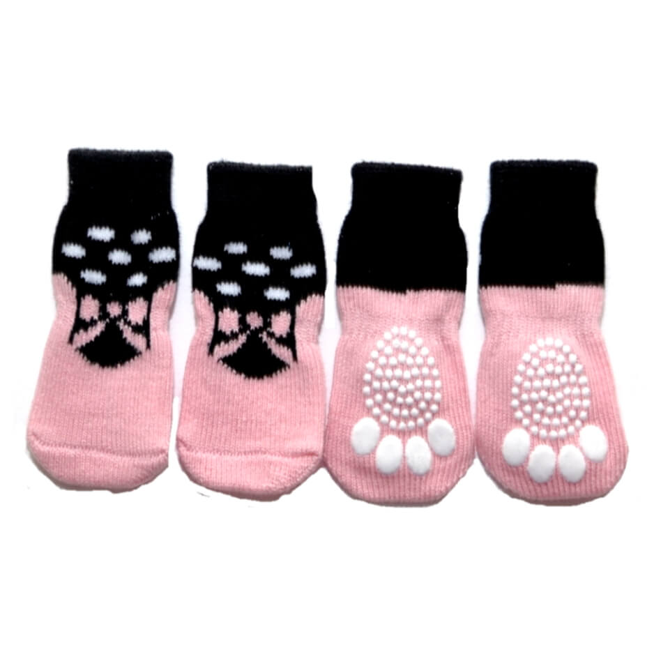 Set of four pink pet socks with black paw prints on a white background
