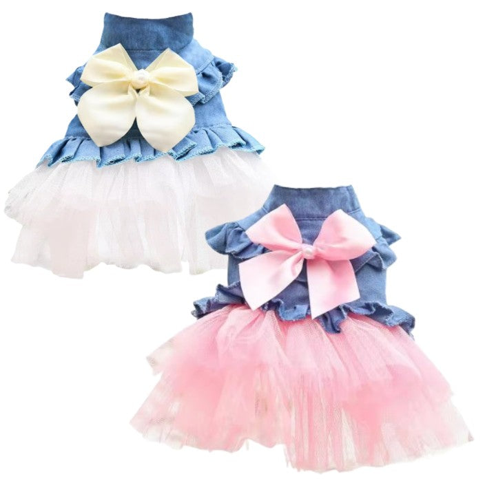 Two pet dresses with denim tops and ruffled tutu skirts in blue and pink on a white background.