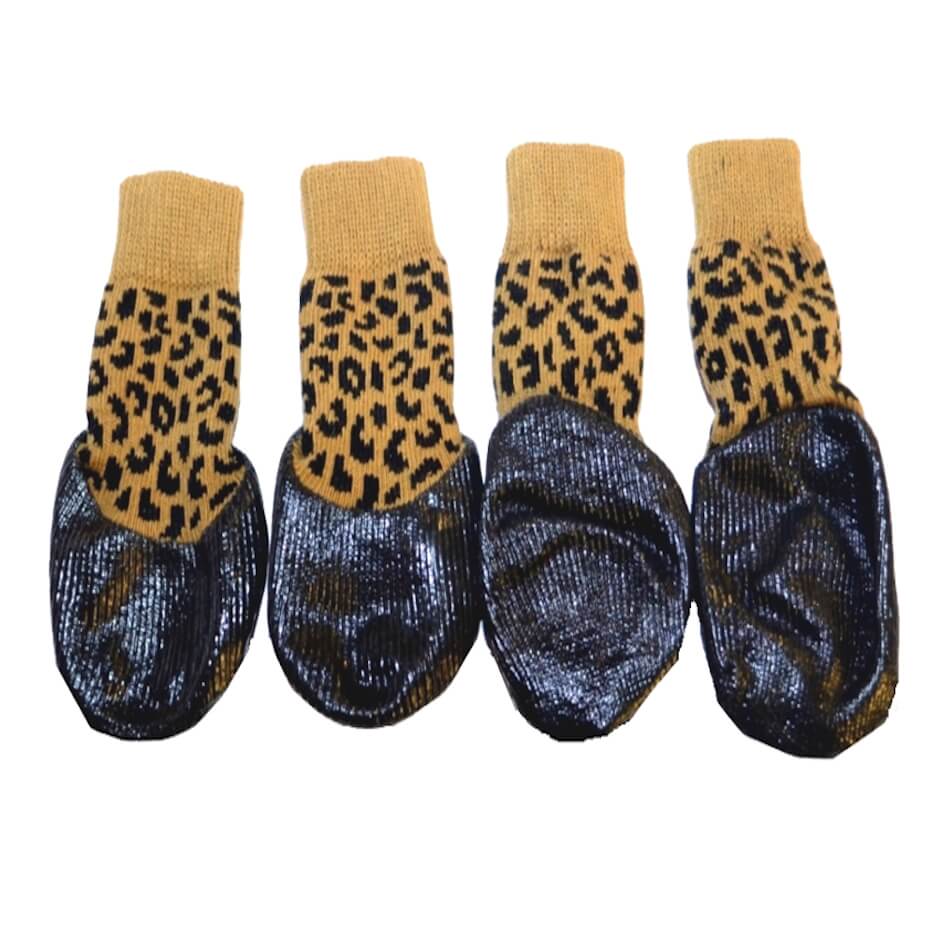 Four pairs of dog socks with leopard print tops and dark blue soles on a white background.