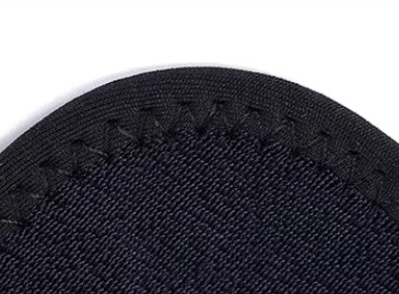 Dog short leg knee support single close-up of black textured material  