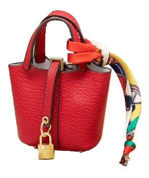 Red handbag with a colorful strap and gold padlock on a white background