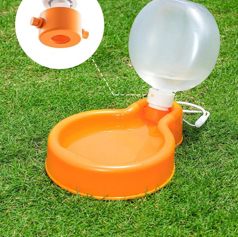 Orange and clear plastic water dispenser on grass