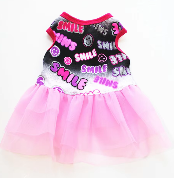 Dog dress with 'SMILE' text and pink tutu on a white background